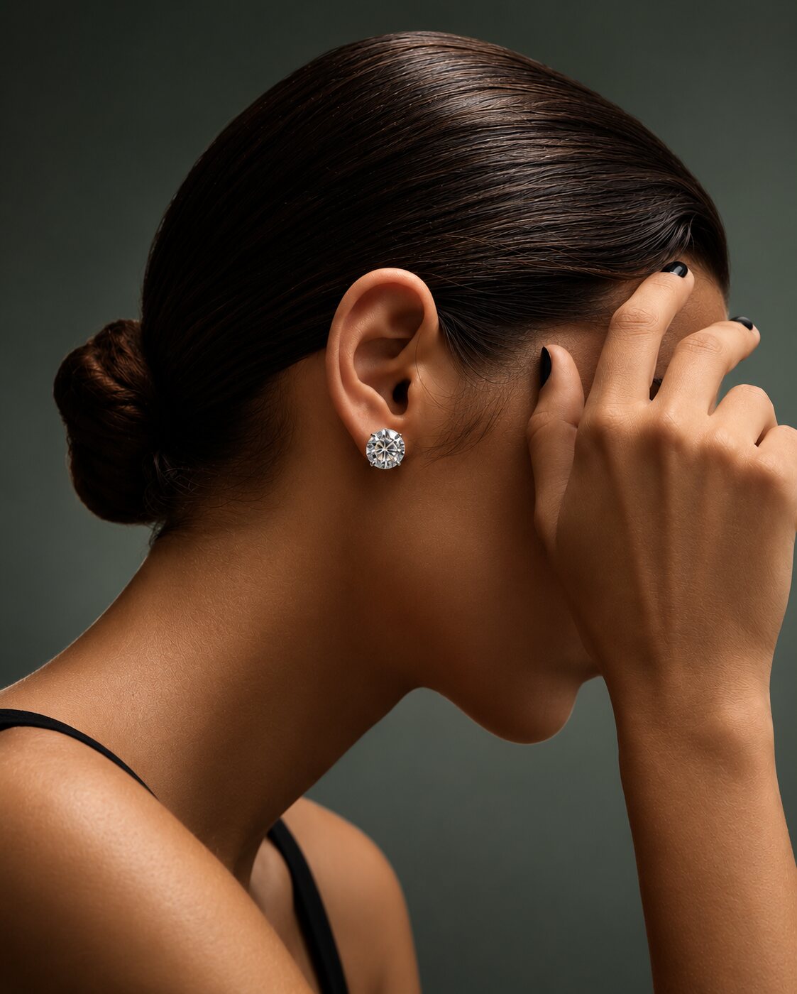 Profile of a model wearing a round brilliant diamond stud earring